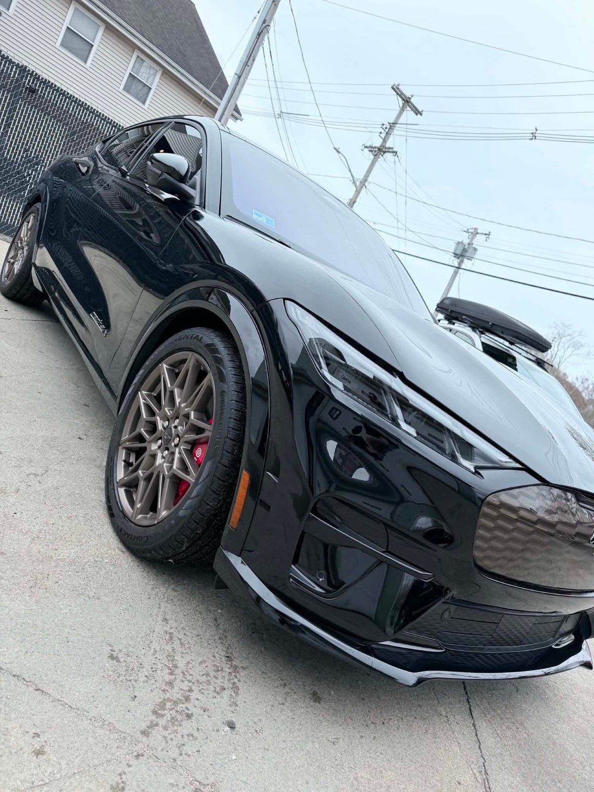 Black Ford Mustang GT350 with red brake calipers detailed to a deep gloss