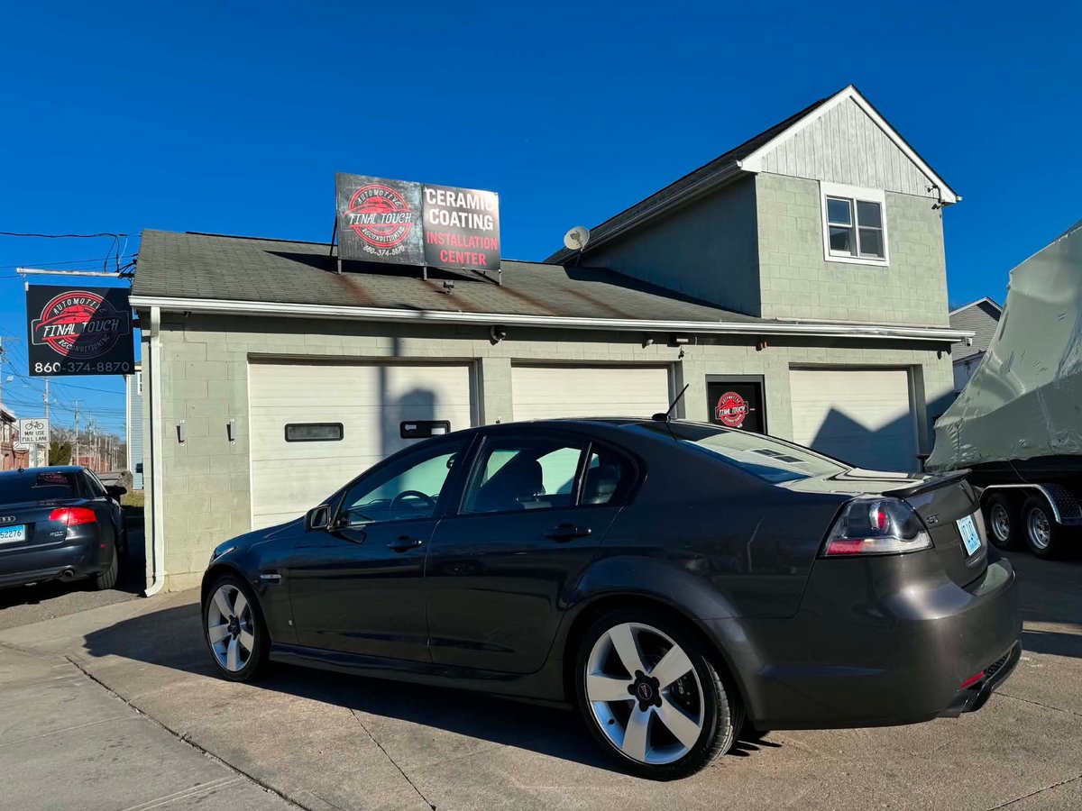 Black sedan finished with a showroom shine outside The Final Touch's Westerly shop