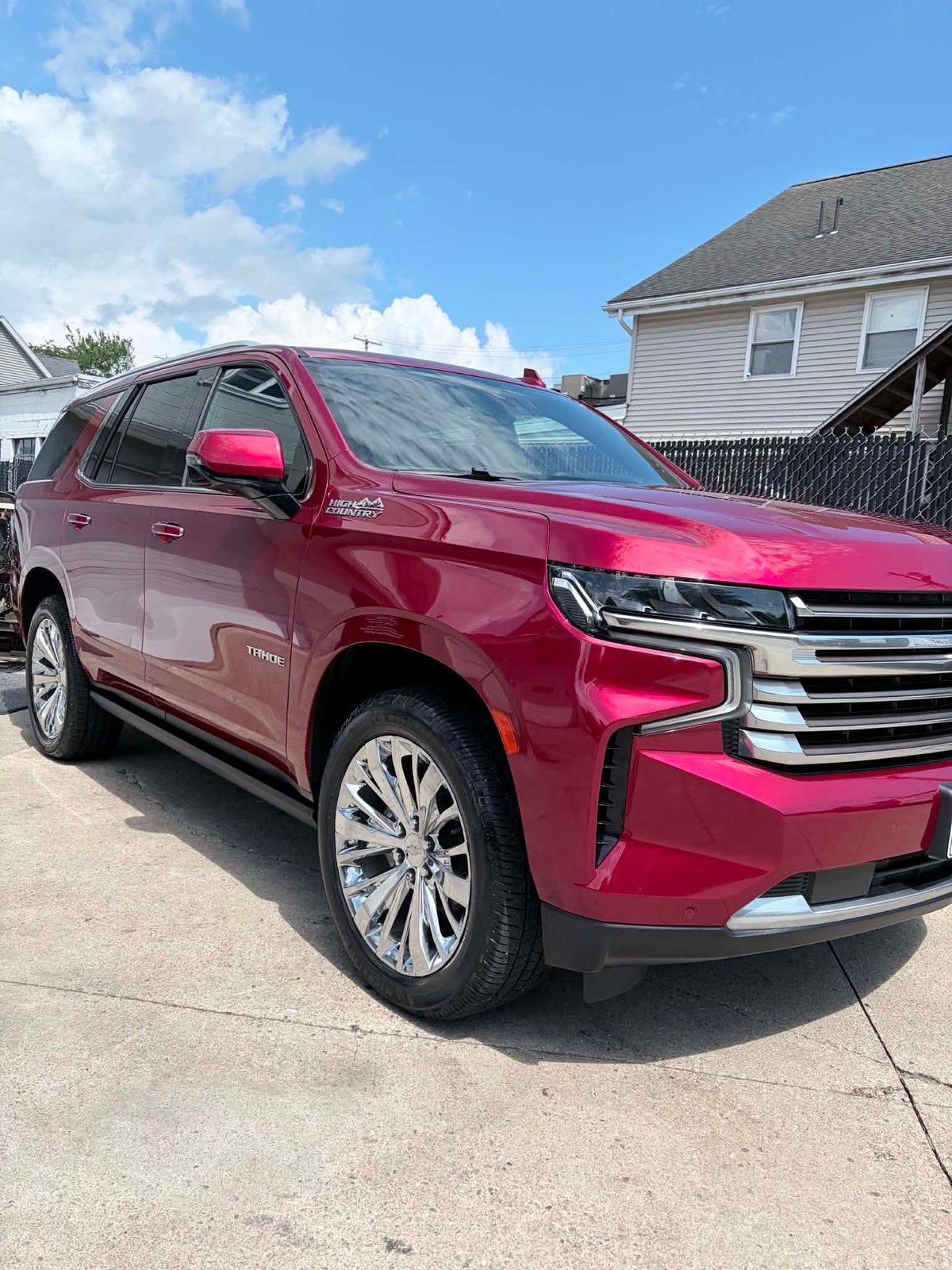 Magenta Chevrolet Tahoe detailed to a high-gloss shine