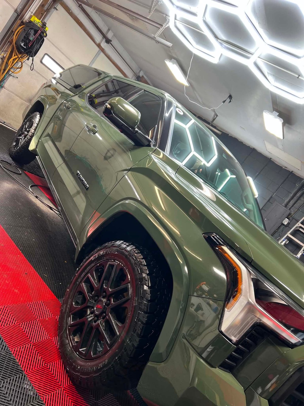 Olive green pickup truck with a deep, glossy finish after detailing