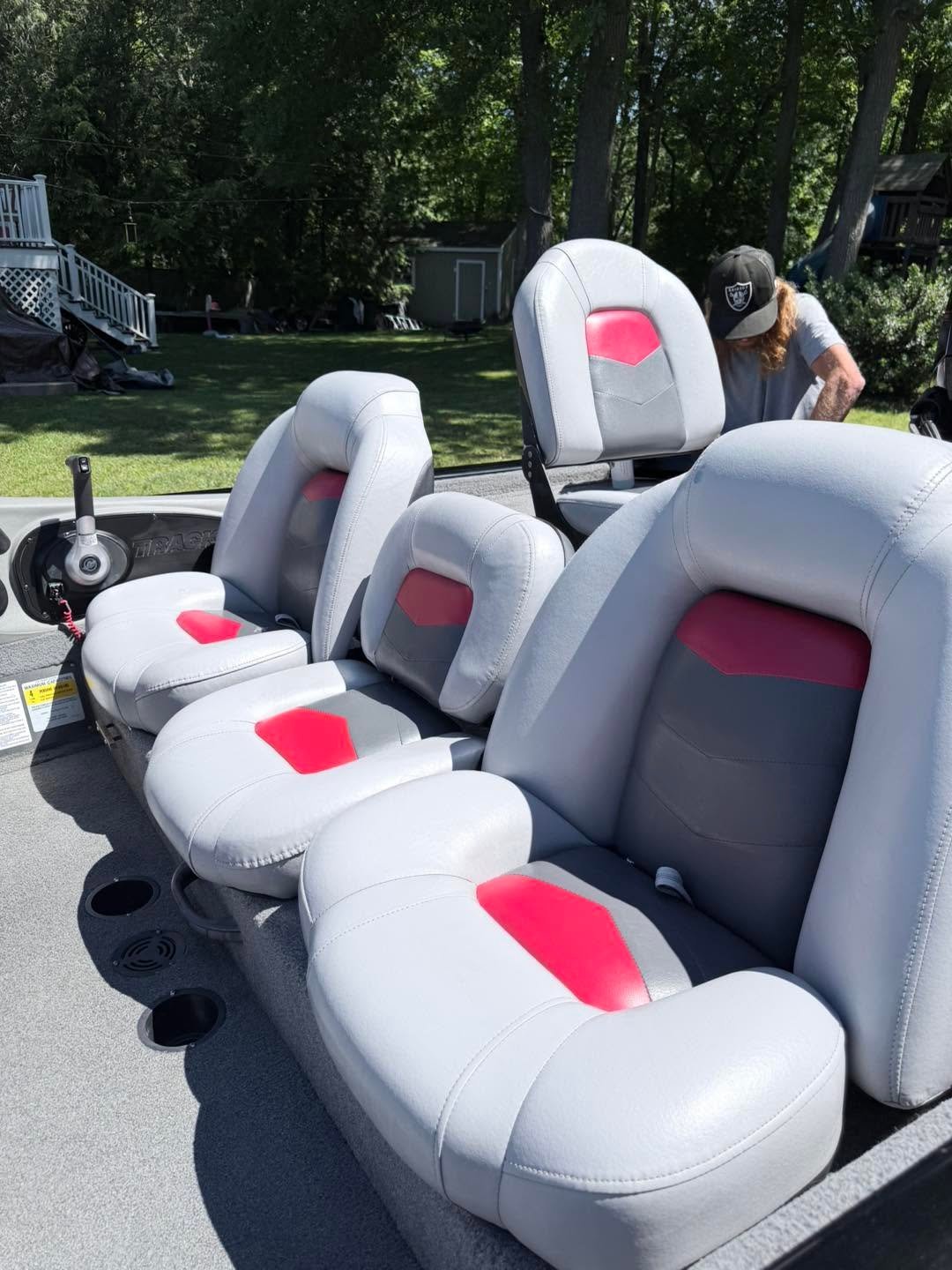 Close-up of restored white and red boat seats after vinyl and upholstery detailing