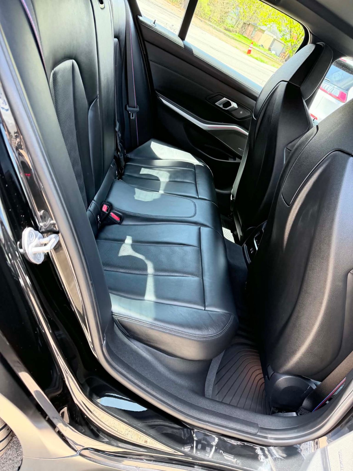 Pristine black leather rear seat after a full interior detail