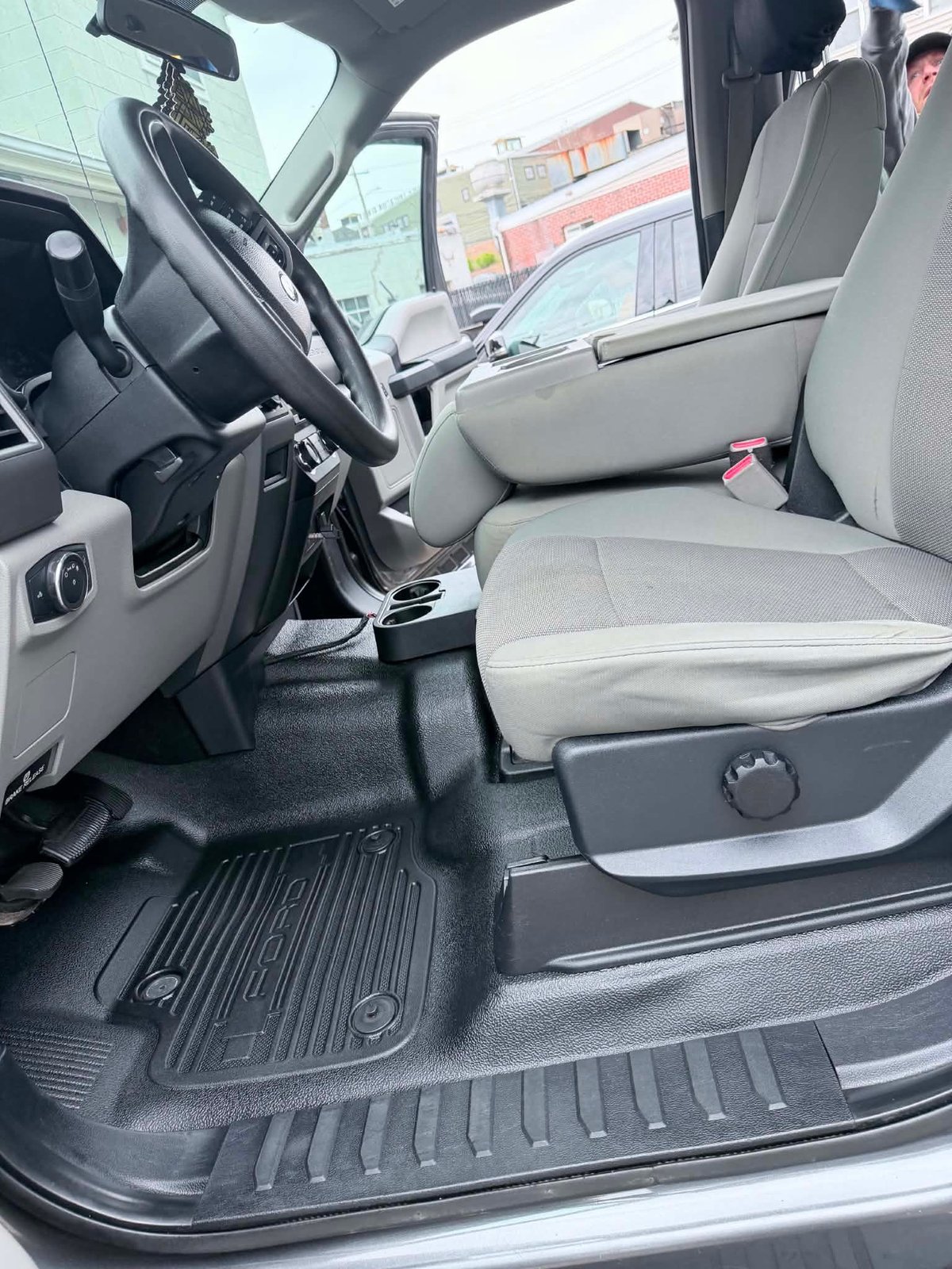 Freshly detailed truck cab — gray cloth seats and clean WeatherTech floor mats